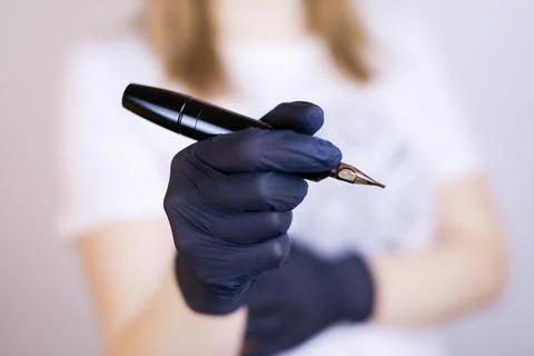Master of permanent makeup with a tool in his hand Stock Photos