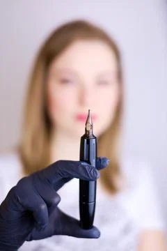 Master of permanent makeup with a tool in his hand Stock Photos