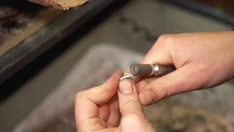 Master polishes the finished product using a special grinding device Stock Footage 72966710