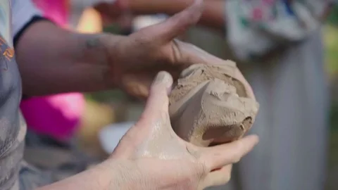 Master Potter hangs a piece of clay for modeling dishes. At the open-air fair Stock Footage 79845897