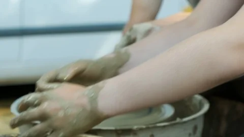 The master Potter teaches the child to make a clay jug on a modern Potter's w Stock Footage 125407129