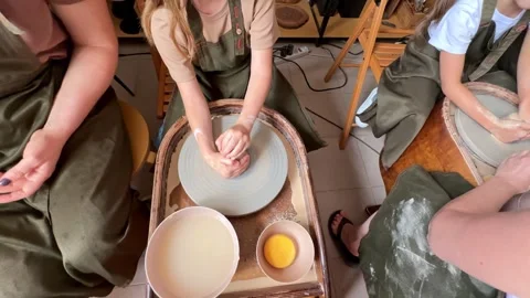 Master potter teaches children and their moms to make a clay jug  Stock Footage 277790212