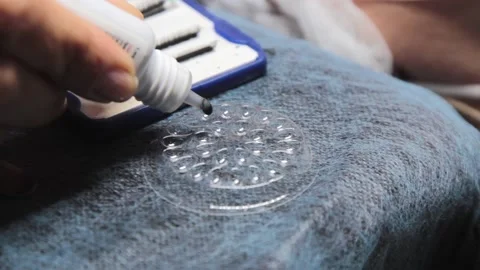 The master pours eyelash glue into a dish Stock Footage 155105757