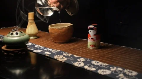 Master pours specially prepared water for cooking Japanese tea Matthia Stock Footage 107822624
