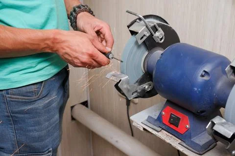 The master prepares, sharpens the tool for work. Stock Photos