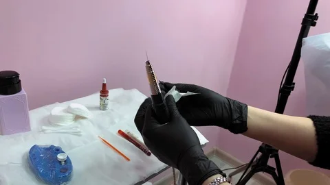 Master prepares tools for work. Cosmetology procedure. Applying red permanent  Video stock 119892503