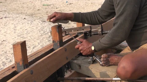 Master with primitive tools build wooden boat near Ganges river, Varanasi Stock Footage 31850479