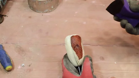 The master processes the wooden handle from the knife with wax. Stock Footage 156180650