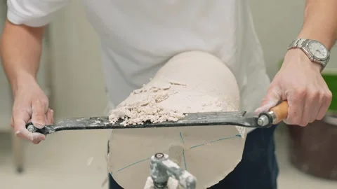 The master of prosthetics prepares a plaster mold for a prosthetic leg. The Stock Footage 263039099
