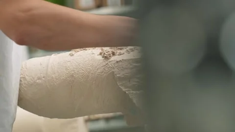 The master of prosthetics prepares a plaster mold for a prosthetic leg. The Stock Footage 263039337