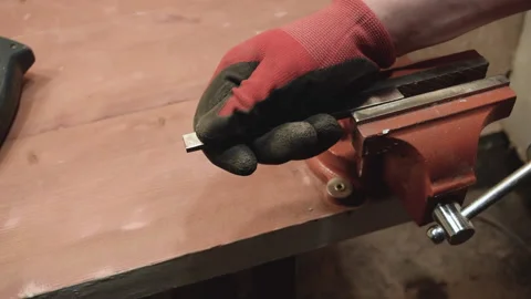 The master pulls the iron billet out of the vise. Stock Footage 156173250