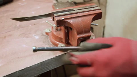 The master pulls the sharpened knife out of the vice. Stock Footage 156180747