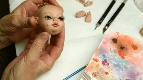 Master puppet examines produced to her dolls head. Stock Footage 128687663