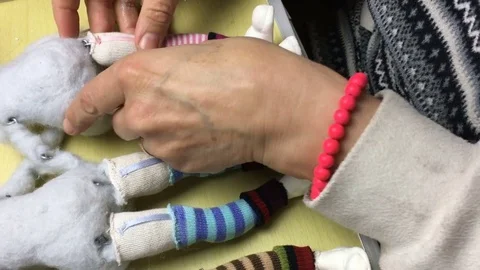Master puppeteer makes shoes and clothes for dolls. Stock Footage