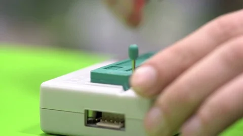 Master puts the BIOS chip in the programmer for firmware Stock-Footage 71247722