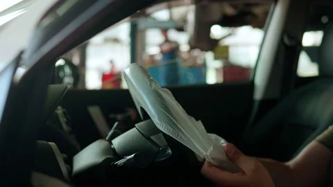 The master puts a cover on the steering wheel of the car Stock Footage 158508258