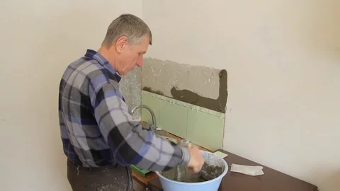 Master puts glue for tiles on the wall. Stock Footage 101685530