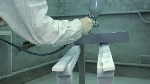 Master puts on a layer of gray gloss paint on the surface of the guitar and Stock Footage 74021847