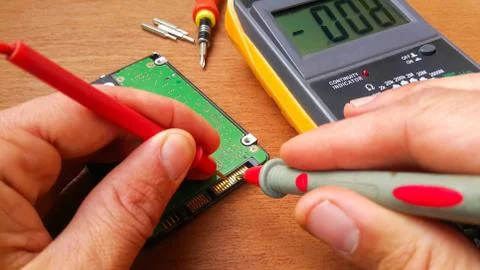 The master of radio engineering repairs a part of the computer Stock Photos