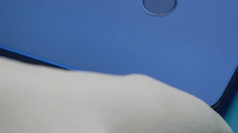 The master removes the back cover of the broken smartphone with a special tool. Stock Footage 142275846