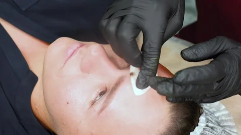 The master removes excess eyebrow makeup paint after the procedure. Stock Footage 131247606