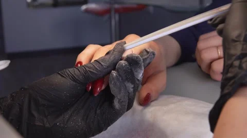 Master removes the old nail coating Stock Footage 270322112