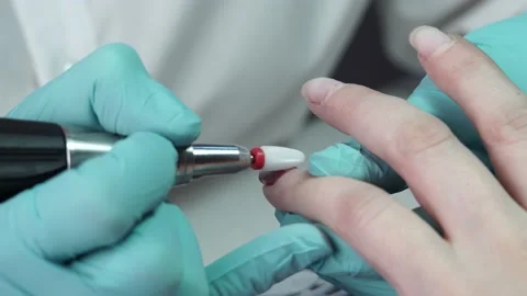 Master is removing the gel polish from the customer's nail with nail drill Stock Footage 194463735