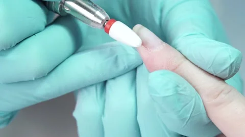 Master is removing the gel polish from the customer's nail with nail drill Stock-Footage 194463756