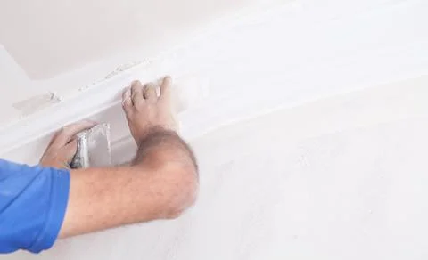 Master renovating the ceiling. Renovation Stock Photos