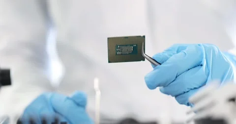 Master repairman holding computer processor with tweezers in laboratory 4k movie Stock Footage 245356068