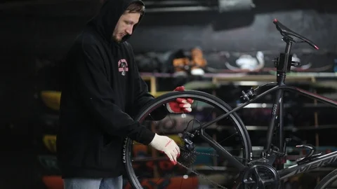The master repairs the bike in the workshop Stock Footage 105877887
