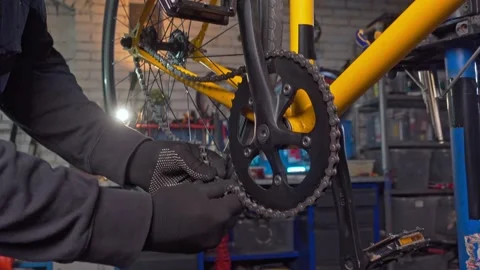Master repairs the chain on the bike. Workshop, bicycle repair Stock Footage 193484637