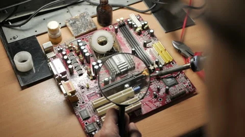 Master repairs the computer motherboard. Condenser explosion Stock-Footage 99089654