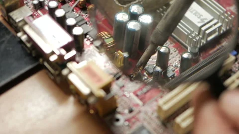 Master repairs the computer motherboard. Condenser explosion Stock Footage 99090139