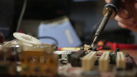 Master repairs the computer motherboard. Condenser explosion Stock-Footage 99091113