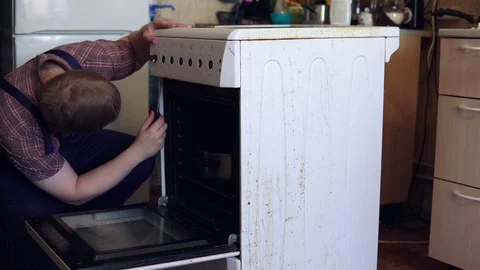 The master repairs the electric stove. Stock Footage 103035429
