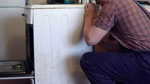 The master repairs the electric stove. Stock Footage 103102192