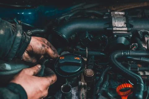 The master repairs the engine in the car service during a malfunction 스톡 사진