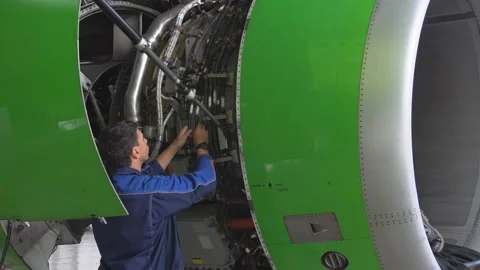 Master repairs the engine of a passenger aircraft. 4k Stock Footage 95639715