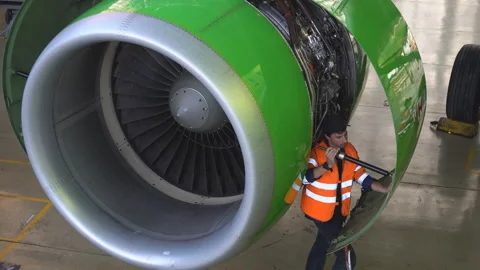 Master repairs the engine of a passenger aircraft. 4k Stock Footage 95642587