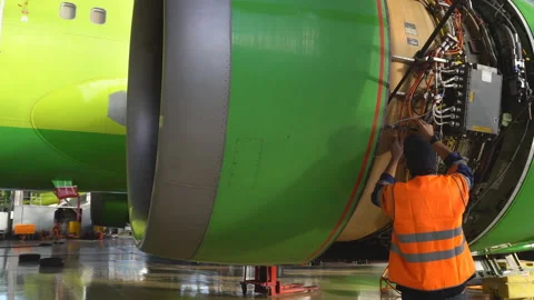 Master repairs the engine of a passenger aircraft. 4k Stock Footage 95643106