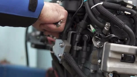 A master repairs a fuel-injected outboard motor. Stock Footage 266985987