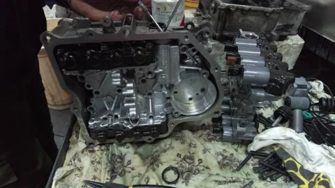 Master repairs gearbox in service with hands twists bolts on table Stock Footage 223403763