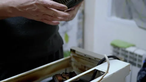 Master Repairs the Old Dirty, Rusty Kitchen Hood in the Kitchen. 4K. Close-up Stock Footage 229464058