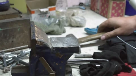 Master rivets a rivet into a plastic rod and then checks the quality of the work Stock Footage 253090166