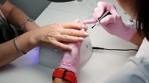 The master in the salon does manicure in his hands Video stock 156822088