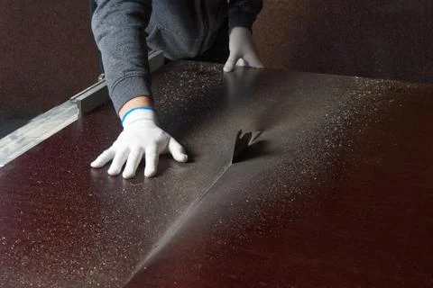 The master saws a brown building shield. master saws plywood on a circular saw Stock Photos