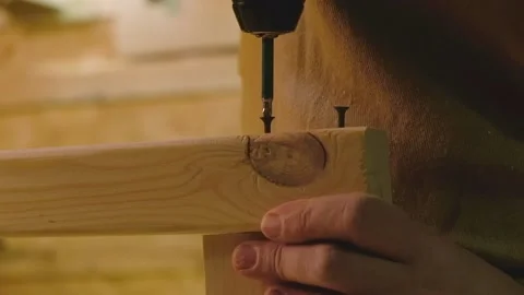 The master screws screws into the boards with a screwdriver Stock Footage 182224290