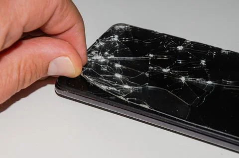 Master in the service center changes the broken glass of the screen in the smart Stock Photos