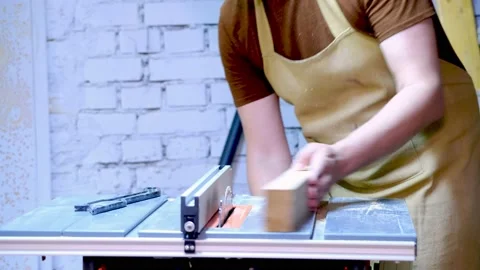 The master sets the board on a circular saw Stock Footage 177007837